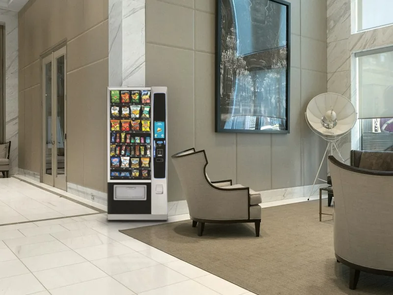 Snack vending machine in a bright apartment building lobby